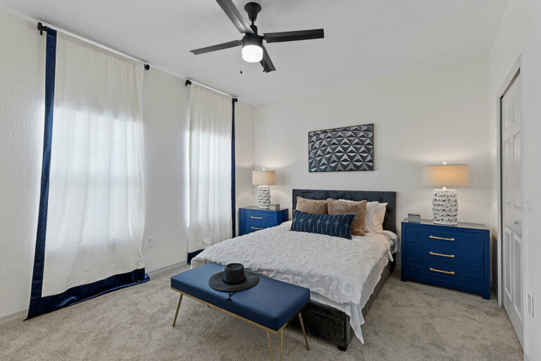 model bedroom with modern furniture, ceiling fan and ceiling to floor curtains